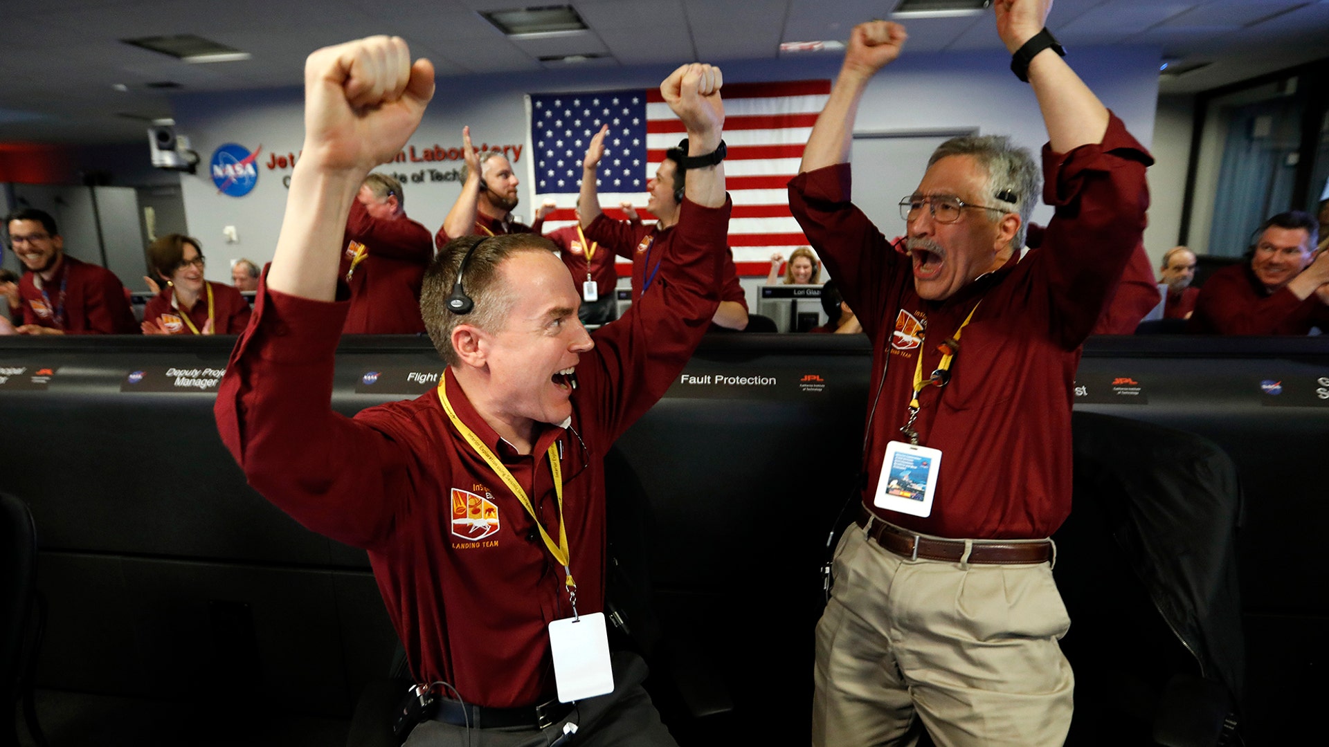 Engineers Kris Bruvold and Sandy Krasner celebrate at the Jet Propulsion Laboratory as the NASA InSight lander touches down on Mars, in Pasadena, Nov. 26, 2018.