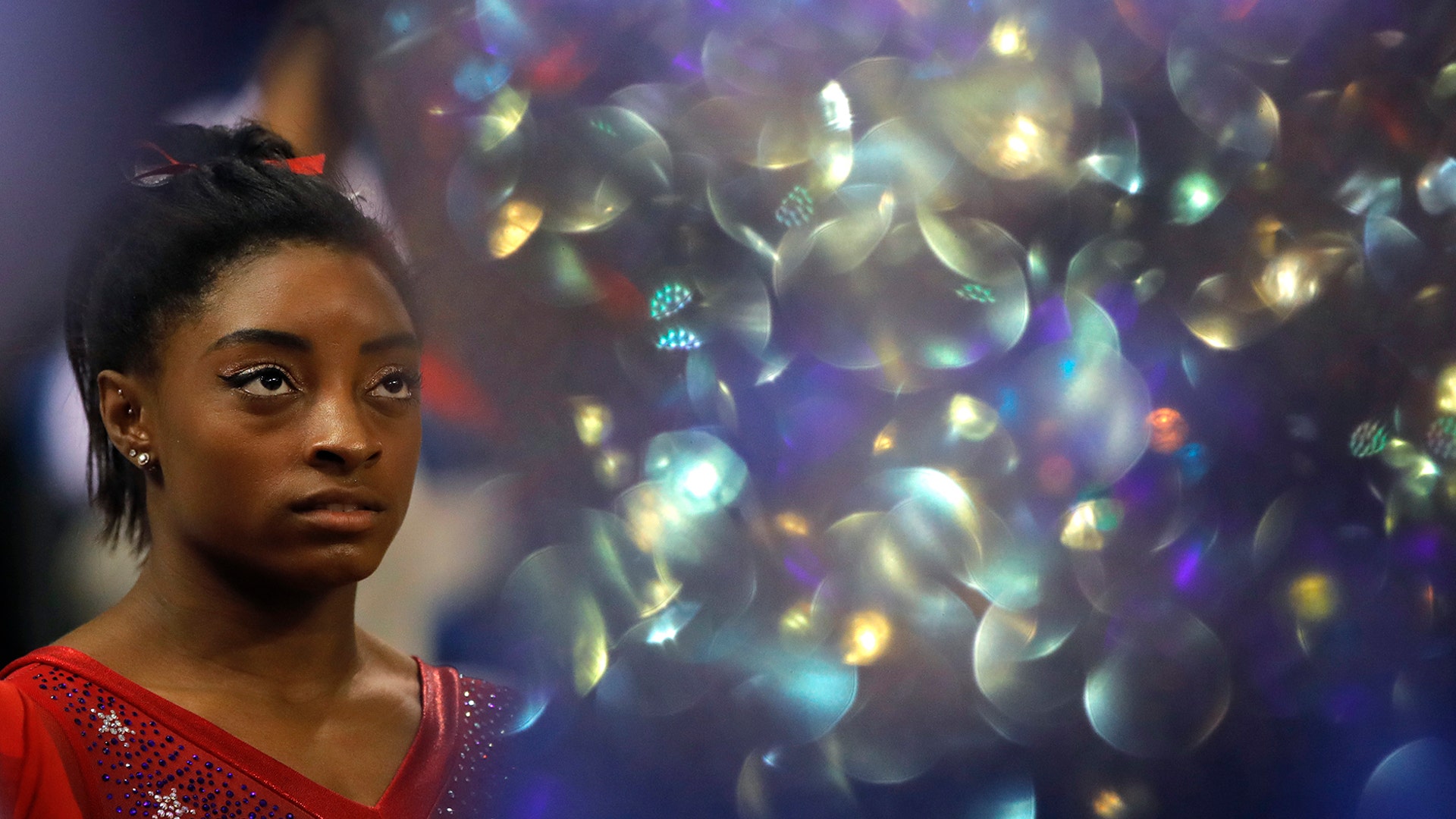 World champion Simone Biles of the United States waits for the medal ceremony after the women's team final at the Gymnastics World Championships in Doha, Qatar, Oct. 30, 2018.