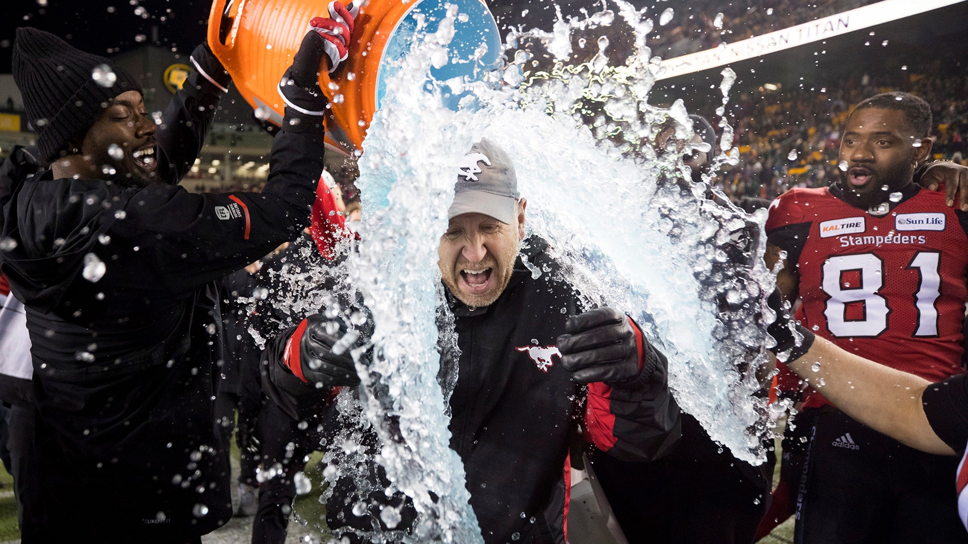 Calgary Stampeders coach Dave Dickenson is doused with ice water after the Stampeders defeated the Ottawa Redblacks in the Canadian Football League Grey Cup in Edmonton, Alberta, Nov. 25, 2018. 