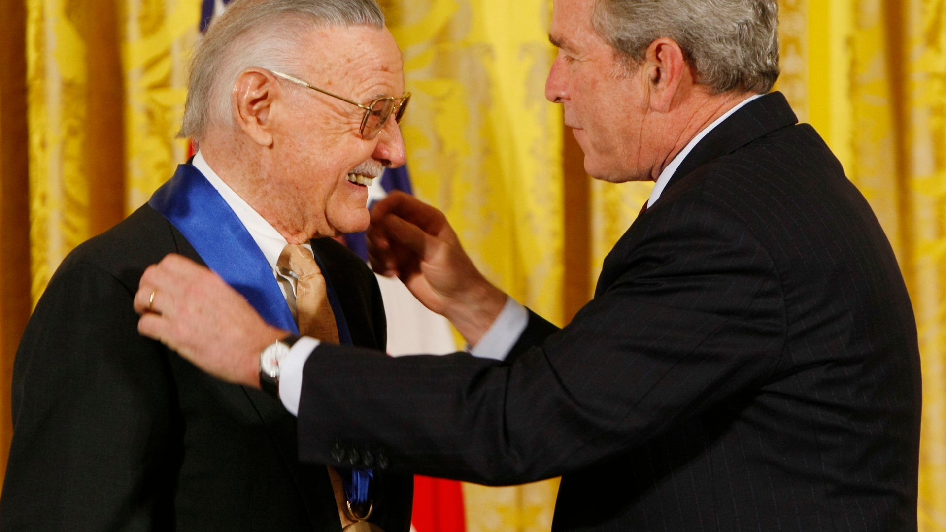 FILE - In this Nov. 17, 2008 photo, President George W. Bush presents the 2008 National Medals of Arts to comic book creator Stan Lee, in the East Room of the White House in Washington.