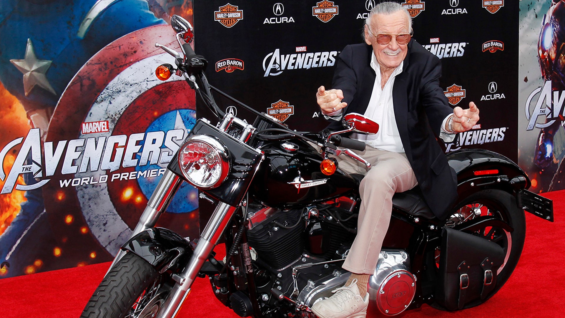 Comic book creator and executive producer Stan Lee poses on a motorcycle at the world premiere of the film "Marvel's The Avengers" in Hollywood, California, April 11, 2012. "I wrote so many I don't even know. I wrote either hundreds or thousands of them," he told the AP in 2006.