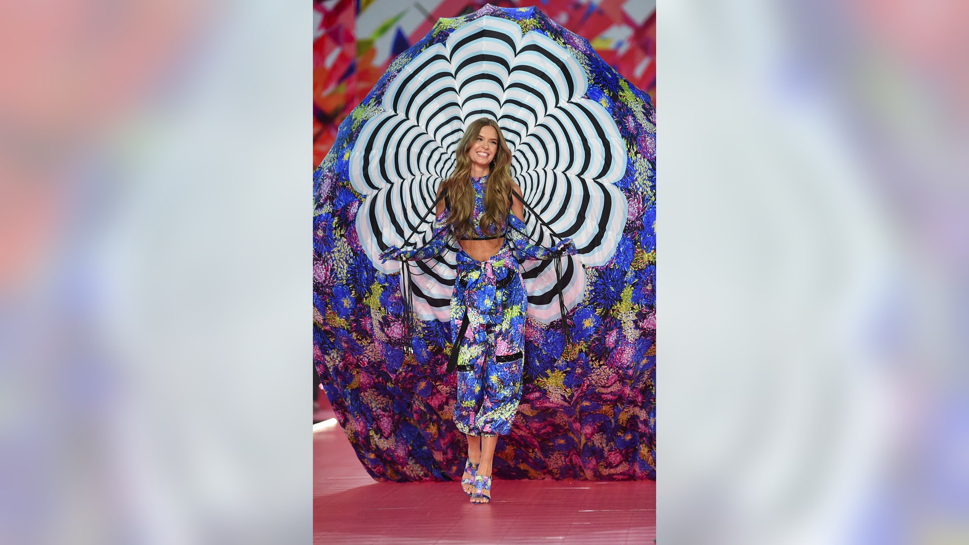 Josephine Skriver struts down the runway in neon-patterned pantaloons with a matching top and whimsical parachute. 