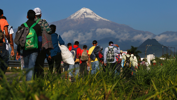 Migrants straggle into Mexico City to shelter at stadium