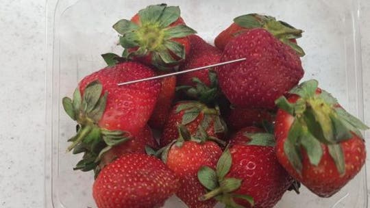 Strawberry needle investigation leads to Australian woman’s arrest, police say