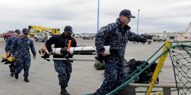 U.S. Navy personnel load equipment onto the Skandi Patagonia ship in Comodoro Rivadavia, Argentina, Tuesday, Nov. 21, 2017. Experts worry that if the ARA San Juan submarine is intact but submerged, its crew might have only enough oxygen to last seven to 10 days.