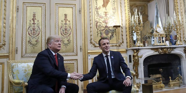 President Donald Trump shakes hands with French President Emmanuel Macron inside the Elysee Palace in Paris Saturday Nov. 10, 2018. Trump is joining other world leaders at centennial commemorations in Paris this weekend to mark the end of World War I.