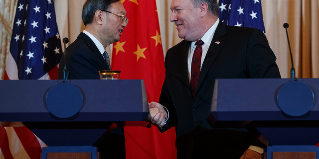 Secretary of State Mike Pompeo, right, shakes hands with Chinese Politburo Member Yang Jiechi at the conclusion of a news conference at the State Department in Washington, Friday, Nov. 9, 2018. (AP Photo/Carolyn Kaster)