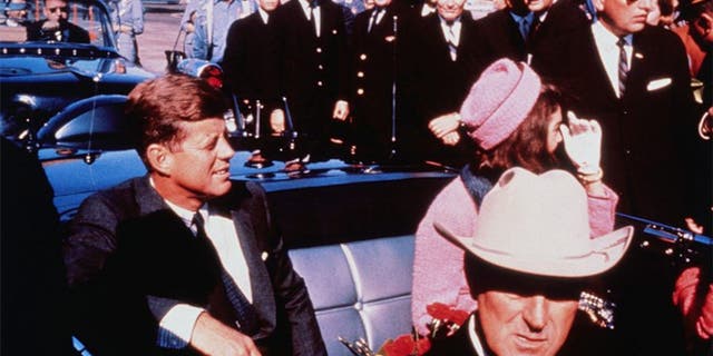 Texas Gov. John Connally (foreground) looks on as President Kennedy and first lady Jacqueline Kennedy settle into the rear seats of their limo as their motorcade prepares to head to downtown Dallas on Nov. 22, 1963.