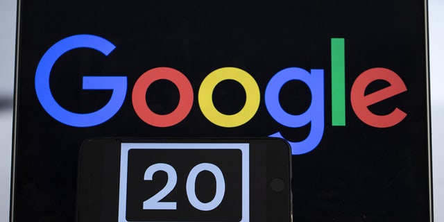 A screen of a mobile phone shows the number of '20' referring to the 20th anniversary of Google.