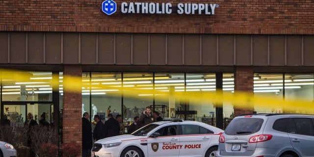Authorities investigate the scene at a Catholic Supply store where a gunman went into the religious supply store, sexually assaulted at least one woman and shot a woman in the head.