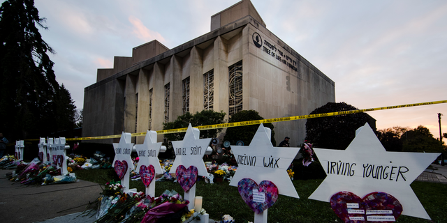 FILE - In this Oct. 29, 2018, file photo, a makeshift memorial stands outside the Tree of Life synagogue in the aftermath of a deadly shooting at the in Pittsburgh. A moment of silence to honor the 11 people killed in the synagogue shooting is planned for a downtown Pittsburgh park, on Friday, Nov. 9. (AP Photo/Matt Rourke, File)
