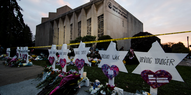 FILE - In this Oct. 29, 2018, file photo, a makeshift memorial stands outside the Tree of Life synagogue in the aftermath of a deadly shooting at the in Pittsburgh. A moment of silence to honor the 11 people killed in the synagogue shooting is planned for a downtown Pittsburgh park, on Friday, Nov. 9. (AP Photo/Matt Rourke, File)