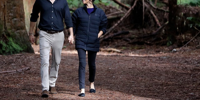Britain's Prince Harry and Meghan, Duchess of Sussex walk through a Redwoods forest in Rotorua, New Zealand, Wednesday, Oct. 31, 2018. Prince Harry and his wife Meghan are on the final day of their 16-day tour of Australia, New Zealand and the South Pacific.