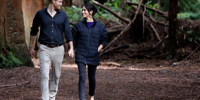 Britain's Prince Harry and Meghan, Duchess of Sussex walk through a Redwoods forest in Rotorua, New Zealand, Wednesday, Oct. 31, 2018. Prince Harry and his wife Meghan are on the final day of their 16-day tour of Australia, New Zealand and the South Pacific.