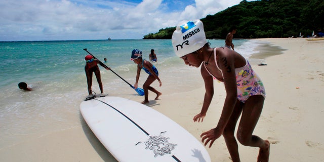 In this June 13, 2009 file photo, children play at a resort beach in Ngerkebesang, Palau.