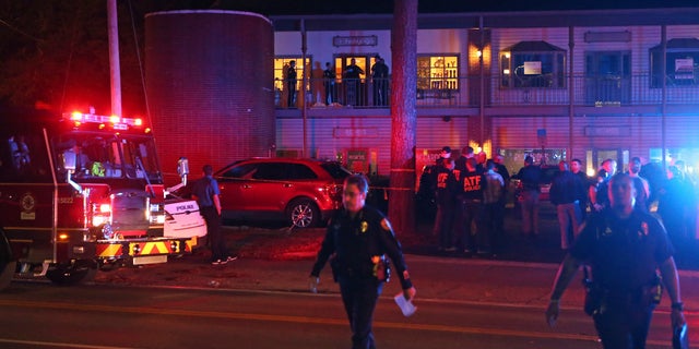 Police investigators work the scene of a shooting, Friday, Nov. 2, 2018, in Tallahassee, Fla. A shooter killed one person and critically wounded four others at a yoga studio in Florida's capital before killing himself Friday, officials said. (AP Photo/Steve Cannon)
