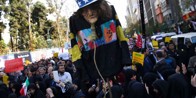 FILE:  An effigy of U.S. government icon "Uncle Sam" is held up by demonstrators during a rally in front of the former U.S. Embassy in Tehran, Iran.
