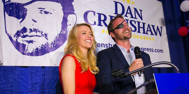 Then-congressional candidate Dan Crenshaw reacts to the crowd with his wife, Tara. (Mark Mulligan/Houston Chronicle via AP, File)