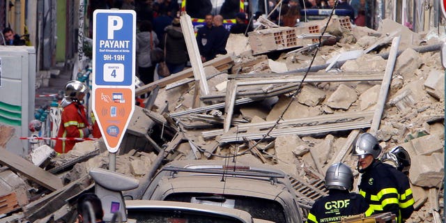 FILE: Firefighters work at the scene where a two buildings collapsed in Marseille, southern France.