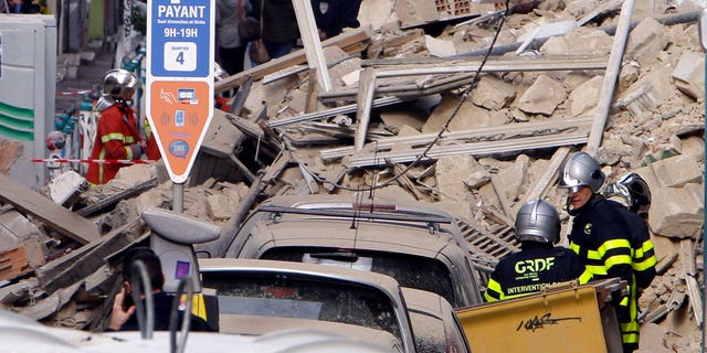 FILE: Firefighters work at the scene where a two buildings collapsed in Marseille, southern France.