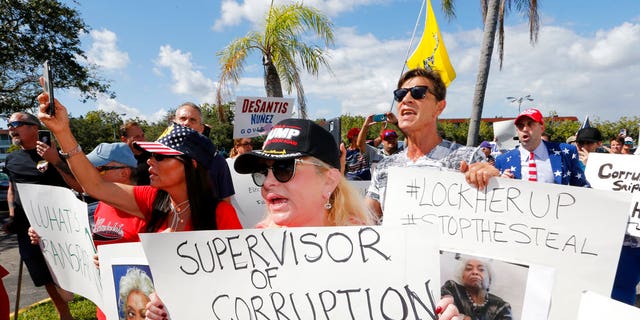 A crowd protests outside the Broward County Supervisor of Elections office Friday, Nov. 9, 2018, in Lauderhill, Fla. A possible recount looms in a tight Florida governor, Senate and agriculture commission race. (AP Photo/Joe Skipper)