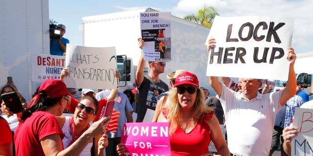 A crowd protests outside the Broward County Supervisor of Elections office Friday, Nov. 9, 2018, in Lauderhill, Fla. Florida is once again at the center of election controversy, but this year there are no hanging chads or butterfly ballots like in 2000. And no angry mobs in suits, at least not yet. (AP Photo/Joe Skipper)