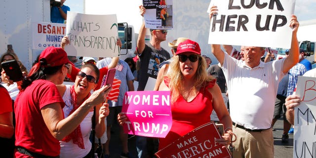 A crowd protests outside the Broward County Supervisor of Elections office Friday, Nov. 9, 2018, in Lauderhill, Fla. Florida is once again at the center of election controversy, but this year there are no hanging chads or butterfly ballots like in 2000. And no angry mobs in suits, at least not yet. (AP Photo/Joe Skipper)