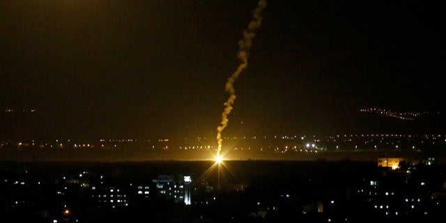Flares fired from Israeli forces light up the night sky in Gaza City, Monday, Nov. 12, 2018, as the Israeli military launched fighter jets to strike "terror targets" throughout the Gaza Strip.