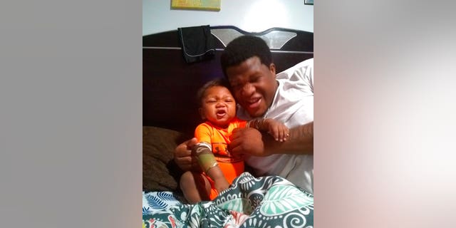 This photo provided by Avontea Boose shows her baby Tristan Roberson and her boyfriend Jemel Roberson.