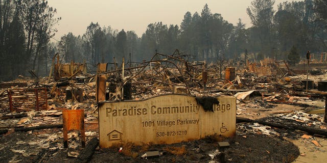 A sign stands at a community destroyed by the Camp Fire, Tuesday, Nov. 13, 2018, in Paradise, California.