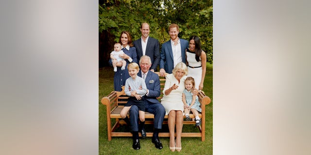 In this handout image provided by Clarence House and taken on Sept. 5, 2018, Britain's Prince Charles poses for an official portrait to mark his 70th Birthday in the gardens of Clarence House, with Camilla, Duchess of Cornwall, Prince William, Kate, Duchess of Cambridge, Prince George, Princess Charlotte, Prince Louis, Prince Harry and Meghan, Duchess of Sussex, in London, England.