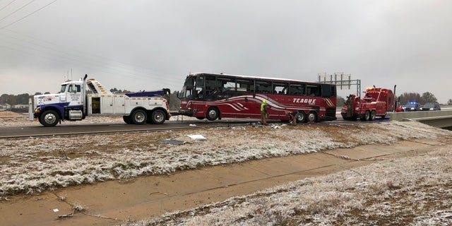 A tour bus is towed on Wednesday, November 14, 2018 after being knocked down on an icy highway north of Mississippi. DeSoto County sheriff's deputy Alex Coker said the bus carrying about 50 people was knocked down shortly after Wednesday noon south of Memphis, Tennessee. The accident occurred while a winter storm swept some parts of the south. County coroner Josh Pounders said two people died in the accident where Interstate 269 and Interstate 22 met. He said the wounded were taken to hospitals in the area, some of them in critical condition.