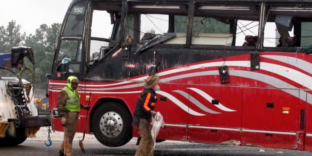 Workers clear the wreckage of a bus accident that killed at least two people and injured dozens on Wednesday, November 14, 2018 in Byhalia, Miss.