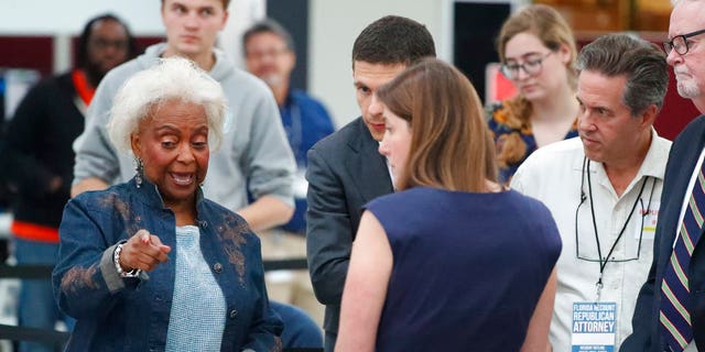 Broward County election supervisor, Brenda Snipes, left, chats with political lawyers during a hand-count, Friday, November 16, 2018 in Lauderhill, Florida.