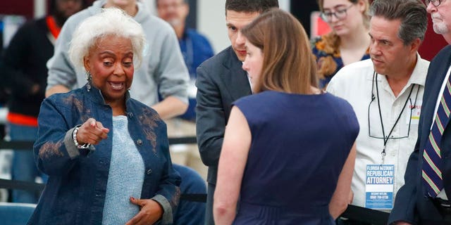 Broward County Supervisor of Elections Brenda Snipes, left, talks with political attorneys during a hand recount, Friday, Nov. 16, 2018, in Lauderhill, Fla.