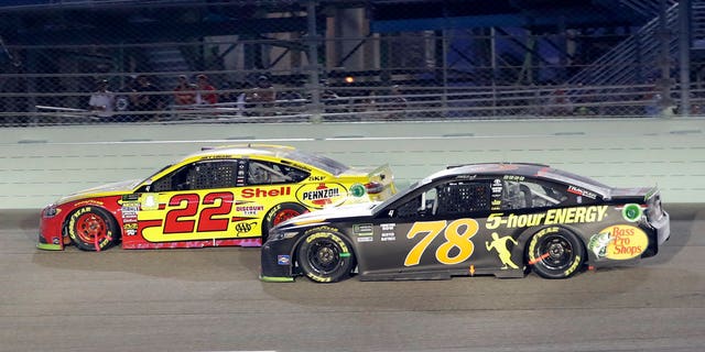 Joey Logano (22) and Martin Truex Jr. (78) drive on the track during the NASCAR Cup Series Championship auto race at the Homestead-Miami Speedway, Sunday, Nov. 18, 2018, in Homestead, Florida.