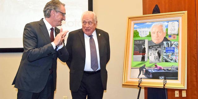 North Dakota Gov. Doug Burgum, left, talks with retired Secret Service agent Clint Hill at the Theodore Roosevelt Rough Rider award at a ceremony on Monday, Nov. 19, 2018, in Washburn, N.D. Gov. Burgum presented Hill with the portrait that will be displayed in the Rough Rider gallery in the state capitol in Bismarck. Hill is the 44th recipient of the state's highest honor.