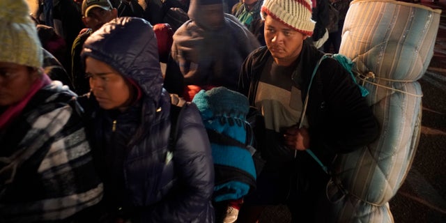 Central American migrants wait to access to the shelter in Tijuana, Mexico, Tuesday, Nov. 20, 2018. At least 3,000 migrants have arrived in Tijuana and the federal government estimates the number of migrants could grow to 10,000 in the coming weeks and months. (AP Photo/Ramon Espinosa)