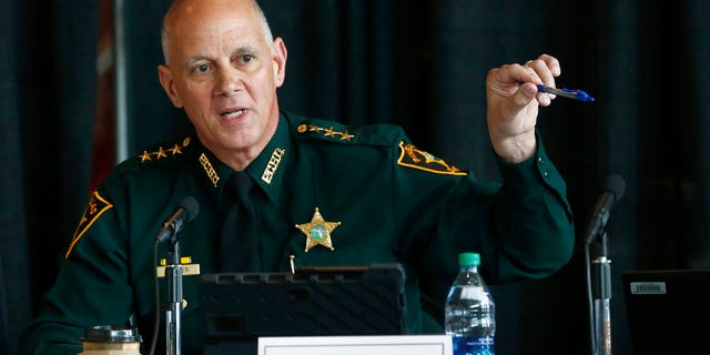 In this June 7, 2018 file photo Marjory Stoneman Douglas High School Public Safety Commission chair and Pinellas County Sheriff Bob Gualtieri gestures as he speaks during a commission meeting in Sunrise, Fla. Guiltieri says he now believes trained, volunteer teachers should have access to guns so they can stop shooters who get past other safeguards.