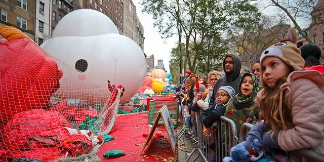 Crowds gather to see giant character balloons being inflated the night before their appearance in the 92nd Macy's Thanksgiving Day parade, Wednesday Nov. 21, 2018, in New York.