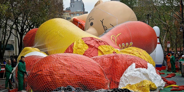 Giant character balloons, including Charlie Brown, are being inflated the night before their appearance in the 92nd Macy's Thanksgiving Day parade, Wednesday Nov. 21, 2018, in New York.