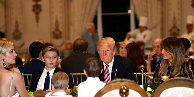 President Donald Trump, center, and first lady Melania Trump, right, sit with their family as they have Thanksgiving Day dinner at their Mar-a-Lago estate in Palm Beach, Fla., Thursday, Nov. 22, 2018. Ivanka Trump, left, and Barron Trump, second from left, attend. (AP Photo/Susan Walsh)