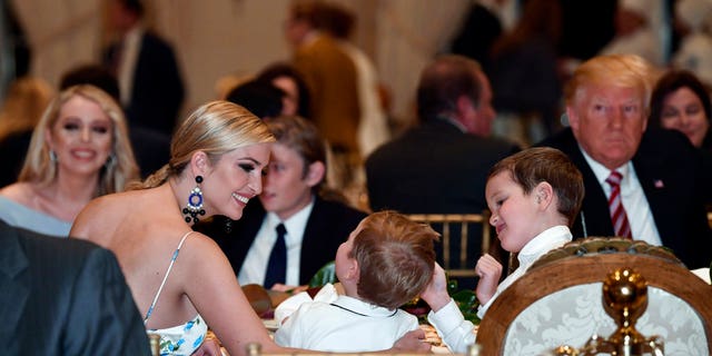 Ivanka Trump talks with her kids as she has Thanksgiving Day dinner at their Mar-a-Lago estate in Palm Beach, Fla., Thursday, Nov. 22, 2018, with President Donald Trump, left, and sister Tiffany Trump, background left.