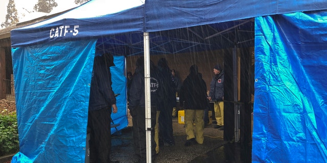 National Urban Research & amp; Rescue Response System The members of the CATF-5 team from Orange County are sheltering from the rain in Paradise, California on Friday. (Associated Press)