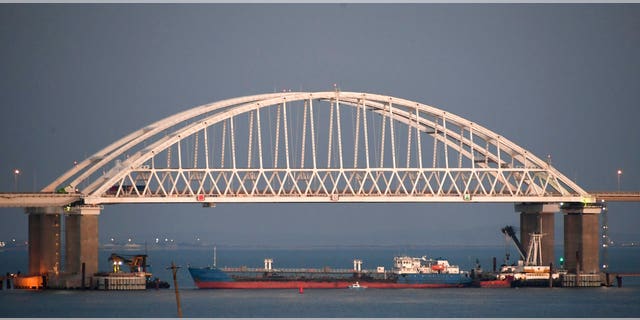 A ship under the Kerch bridge blocks the passage to the Kerch Strait near Kerch, Crimea, Sunday, Nov. 25, 2018.