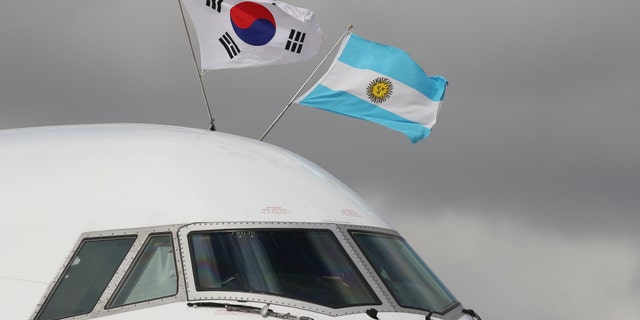 The flags of Argentina, right, and South Korea flutter atop the plane carrying South Korea's President Moon Jae-in on his arrival to the Ministro Pistarini international airport for the G20 Summit in Buenos Aires, Argentina.