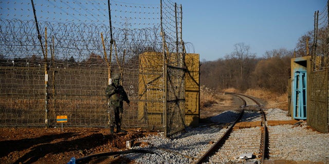 A South Korean soldier stands guard next to the rails which lead to North Korea, inside the demilitarized zone separating the two Koreas in Paju, South Korea Friday, Nov. 30, 2018. (Kim Hong-Ji/Pool Photo via AP)