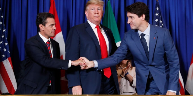 President Donald Trump, Canada's Prime Minister Justin Trudeau, right, and Mexico's President Enrique Pena Neto, left, participate in the USMCA signing ceremony, Friday, Nov. 30, 2018, in Buenos Aires, Argentina. The USMCA was part of a broader effort by Trump to renegotiate U.S. trade with other countries. (AP Photo/Pablo Martinez Monsivais)