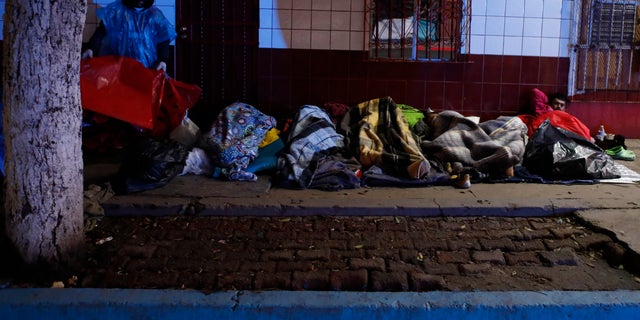 Authorities in the Mexican city of Tijuana have begun moving some of more than 6,000 Central American migrants from an overcrowded shelter on the border to an events hall further away. (AP Photo/Rebecca Blackwell)