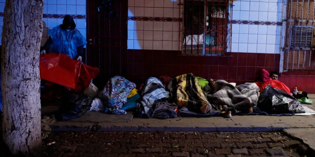 Authorities in the Mexican city of Tijuana have begun moving some of more than 6,000 Central American migrants from an overcrowded shelter on the border to an events hall further away. (AP Photo/Rebecca Blackwell)